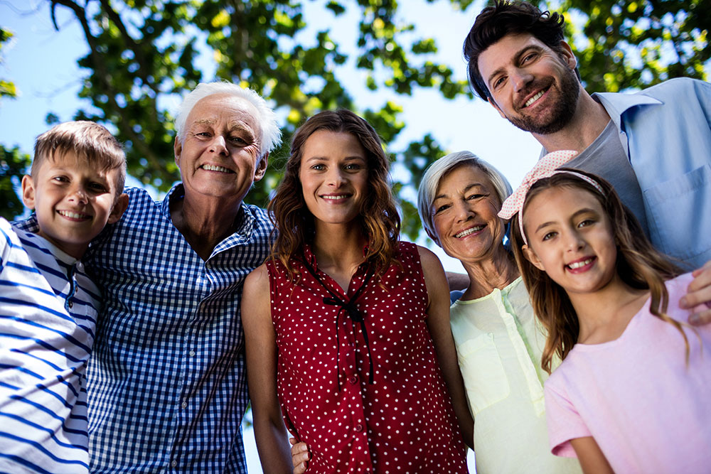 Multi generational family smiling into the camera